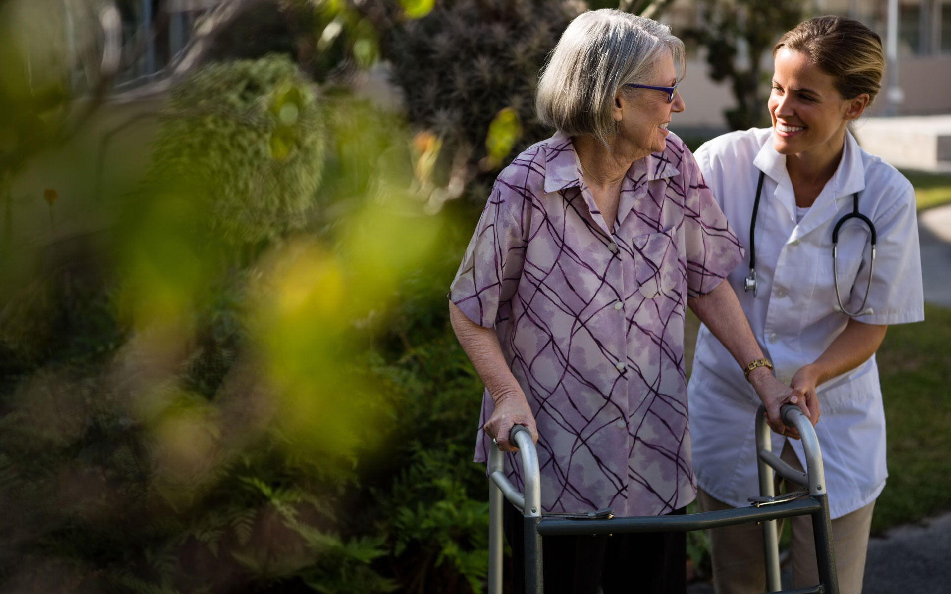 Brentwood_Contact_Us_78791449_web-2 Doctor talking to woman while assisting her in walking